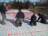 Placing the in-floor heating tubing. Placing the in-floor heating tubing.